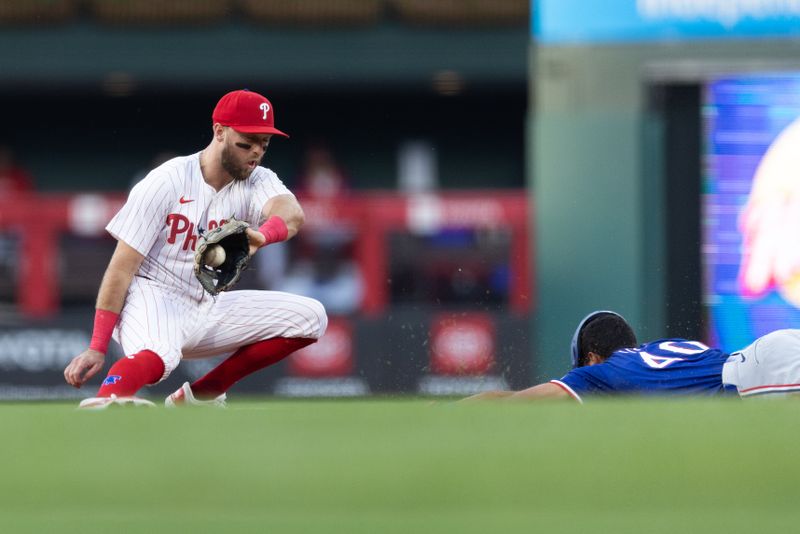 May 21, 2024; Philadelphia, Pennsylvania, USA; Texas Rangers outfielder Derek Hill (40) steals second base past Philadelphia Phillies first base Kody Clemens (2) during the third inning at Citizens Bank Park. Mandatory Credit: Bill Streicher-USA TODAY Sports