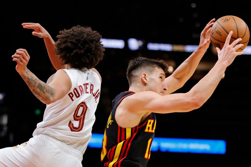 ATLANTA, GEORGIA - JANUARY 20: Bogdan Bogdanovic #13 of the Atlanta Hawks pulls in a rebound over Craig Porter #9 of the Cleveland Cavaliers during the first half at State Farm Arena on January 20, 2024 in Atlanta, Georgia. NOTE TO USER: User expressly acknowledges and agrees that, by downloading and or using this photograph, User is consenting to the terms and conditions of the Getty Images License Agreement. (Photo by Alex Slitz/Getty Images)