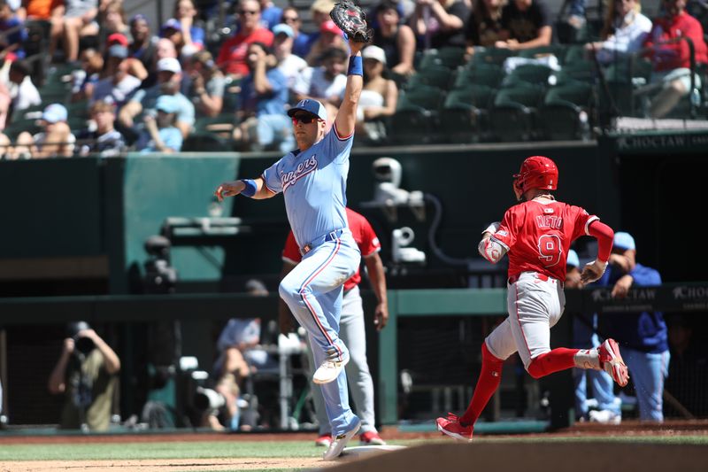 Sep 8, 2024; Arlington, Texas, USA; Texas Rangers first base Nathaniel Lowe (30) makes the put out at first base against Los Angeles Angels shortstop Zach Neto (9) in the sixth inning at Globe Life Field. Mandatory Credit: Tim Heitman-Imagn Images