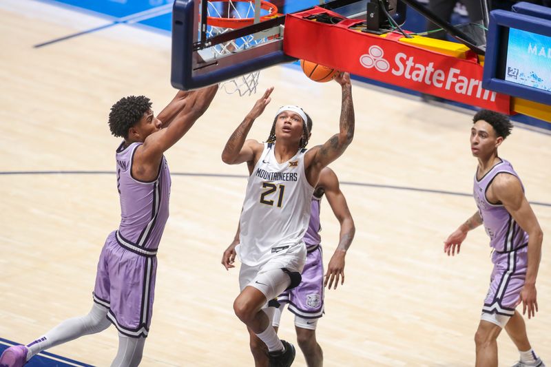 Jan 9, 2024; Morgantown, West Virginia, USA; West Virginia Mountaineers guard RaeQuan Battle (21) drives baseline and shoots against Kansas State Wildcats forward David N'Guessan (1) during the first half at WVU Coliseum. Mandatory Credit: Ben Queen-USA TODAY Sports