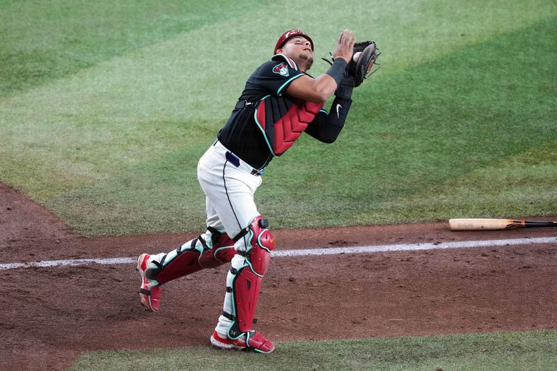 May 4, 2024; Phoenix, Arizona, USA; Arizona Diamondbacks catcher Gabriel Moreno (14) catches a pop up against the San Diego Padres during the sixth inning at Chase Field. Mandatory Credit: Joe Camporeale-USA TODAY Sports