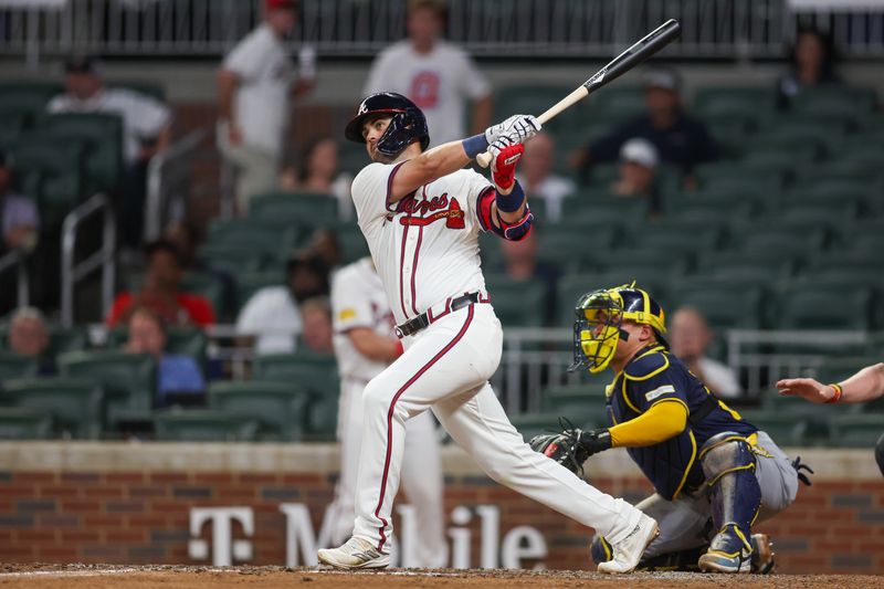 Aug 6, 2024; Atlanta, Georgia, USA; Atlanta Braves second baseman Whit Merrifield (15) hits a single against the Milwaukee Brewers in the eighth inning at Truist Park. Mandatory Credit: Brett Davis-USA TODAY Sports
