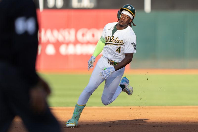 Jul 23, 2024; Oakland, California, USA;  Oakland Athletics outfielder Lawrence Butler (4) runs toward third base during the first inning against the Houston Astros at Oakland-Alameda County Coliseum. Mandatory Credit: Stan Szeto-USA TODAY Sports