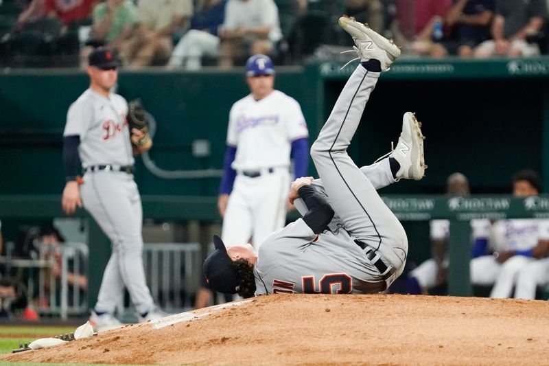 Jun 29, 2023; Arlington, Texas, USA; Detroit Tigers starting pitcher Reese Olson (45) grabs his left leg after being hit by a batted ball by Texas Rangers shortstop Josh Smith (not pictured) during the second inning at Globe Life Field. Mandatory Credit: Raymond Carlin III-USA TODAY Sports