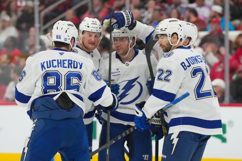 Feb 26, 2026; Raleigh, North Carolina, USA;  Tampa Bay Lightning center Brayden Point (21) is congratulated by right wing Oliver Bjorkstrand (22) center Jake Guentzel (59) defenseman Darren Raddysh (43) and right wing Nikita Kucherov (86) after his goal against the Carolina Hurricanes during the second period at Lenovo Center. Mandatory Credit: James Guillory-Imagn Images