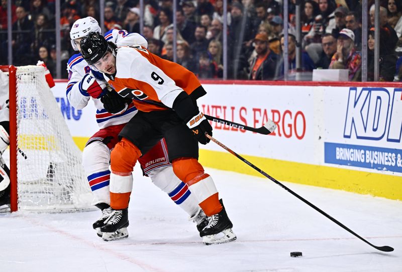 Feb 24, 2024; Philadelphia, Pennsylvania, USA; Philadelphia Flyers defenseman Jamie Drysdale (9) reaches for the puck against New York Rangers left wing Chris Kreider (20) in the second period at Wells Fargo Center. Mandatory Credit: Kyle Ross-USA TODAY Sports