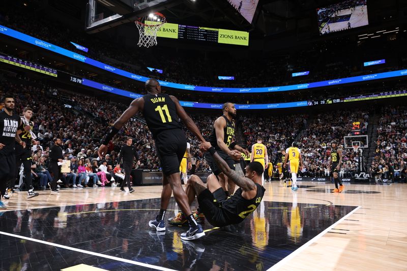 SALT LAKE CITY, UT - FEBRUARY 14: John Collins #20 of the Utah Jazz is helped up by Kris Dunn #11 and Talen Horton-Tucker #5 during the game against the Los Angeles Lakers on February 14, 2024 at Delta Center in Salt Lake City, Utah. NOTE TO USER: User expressly acknowledges and agrees that, by downloading and or using this Photograph, User is consenting to the terms and conditions of the Getty Images License Agreement. Mandatory Copyright Notice: Copyright 2024 NBAE (Photo by Melissa Majchrzak/NBAE via Getty Images)