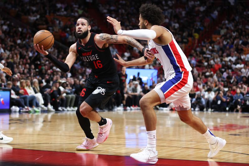 MIAMI, FLORIDA - MARCH 05: Caleb Martin #16 of the Miami Heat drives against Cade Cunningham #2 of the Detroit Pistons during the second quarter of the game at Kaseya Center on March 05, 2024 in Miami, Florida. NOTE TO USER: User expressly acknowledges and agrees that, by downloading and or using this photograph, User is consenting to the terms and conditions of the Getty Images License Agreement. (Photo by Megan Briggs/Getty Images)