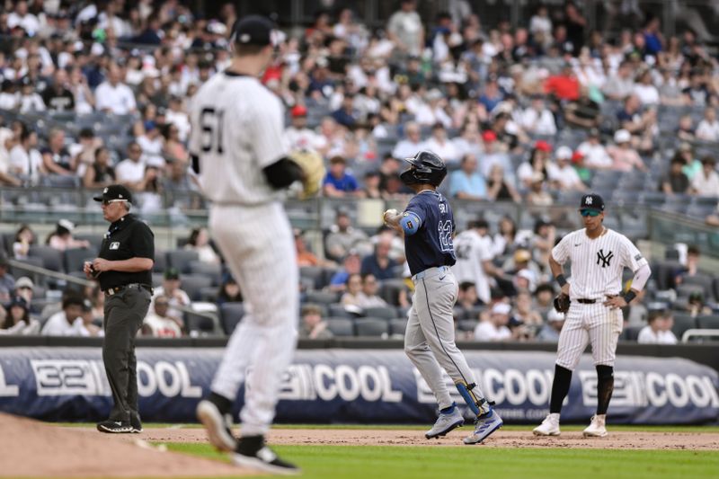 Jul 21, 2024; Bronx, New York, USA; Tampa Bay Rays outfielder Jose Siri (22) rounds the bases after hitting a two-run home run against New York Yankees pitcher Jake Cousins (61) during the seventh inning at Yankee Stadium. Mandatory Credit: John Jones-USA TODAY Sports