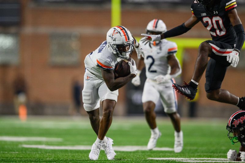 Sep 15, 2023; College Park, Maryland, USA; Virginia Cavaliers wide receiver Malik Washington (4) makes a catch during the first quarter against the Maryland Terrapins at SECU Stadium. Mandatory Credit: Reggie Hildred-USA TODAY Sports