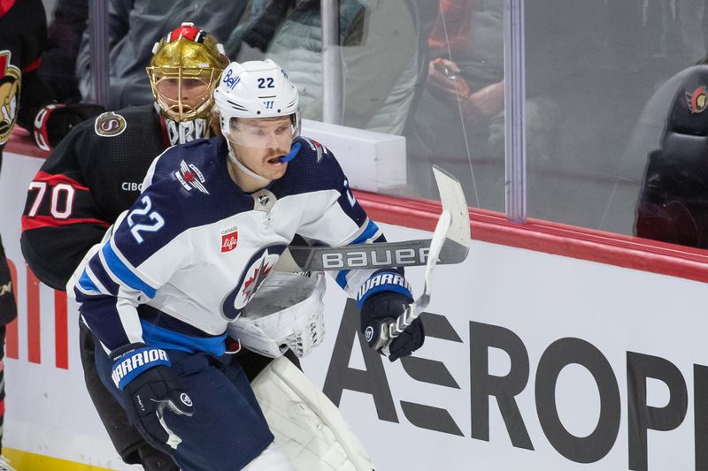 Jan 20, 2024; Ottawa, Ontario, CAN; Winnipeg Jets center Mason Appleton (22) gets caught up in the stick of  Ottawa Senators goalie Joonas Korpisalo (70) in the third period at the Canadian Tire Centre. Mandatory Credit: Marc DesRosiers-USA TODAY Sports