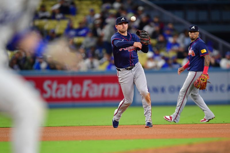 May 4, 2024; Los Angeles, California, USA; Atlanta Braves third baseman Austin Riley (27) throws to first for the out against Los Angeles Dodgers catcher Will Smith (16) during the eighth inning at Dodger Stadium. Mandatory Credit: Gary A. Vasquez-USA TODAY Sports