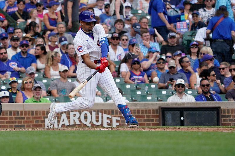 Jul 7, 2024; Chicago, Illinois, USA; Chicago Cubs designated hitter Christopher Morel (5) hits a double against the Los Angeles Angels during the fourth inning at Wrigley Field. Mandatory Credit: David Banks-USA TODAY Sports