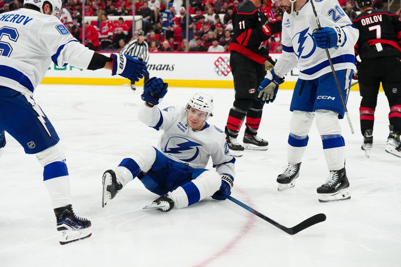 Oct 11, 2024; Raleigh, North Carolina, USA;  Tampa Bay Lightning center Brayden Point (21) celebrates scoring a goal against the Carolina Hurricanes during the second period at PNC Arena. Mandatory Credit: James Guillory-Imagn Images