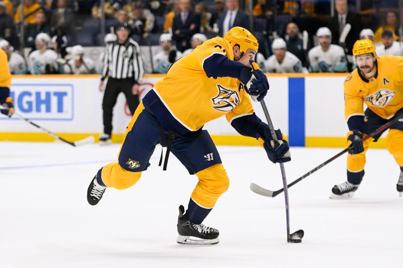 Oct 15, 2024; Nashville, Tennessee, USA;  Nashville Predators defenseman Dante Fabbro (57) takes a shot on goal against the Seattle Kraken during the first period at Bridgestone Arena. Mandatory Credit: Steve Roberts-Imagn Images