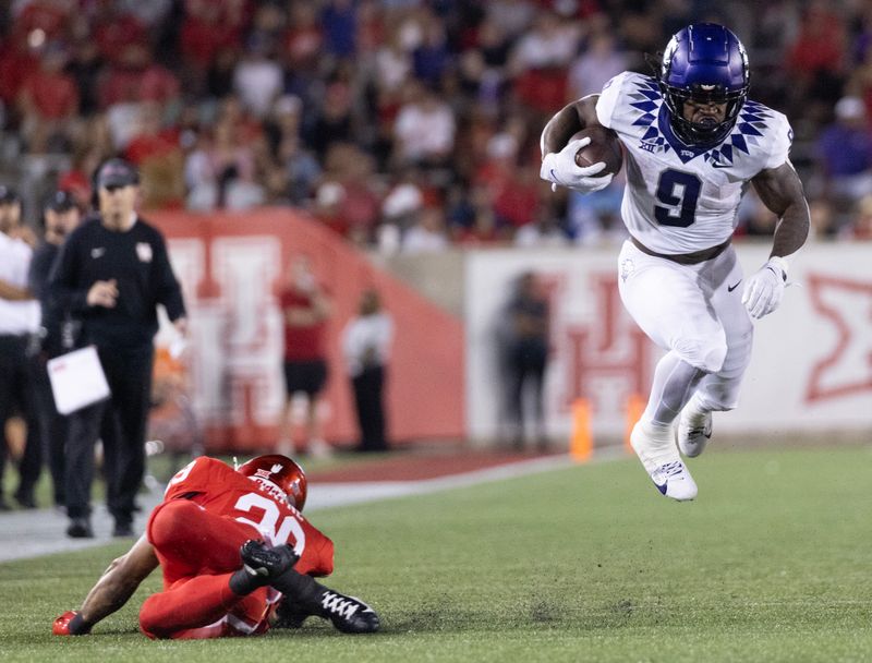 Sep 16, 2023; Houston, Texas, USA; TCU Horned Frogs running back Emani Bailey (9) is tripped by Houston Cougars linebacker Treylin Payne (29) in the second half at TDECU Stadium. Mandatory Credit: Thomas Shea-USA TODAY Sports