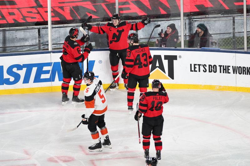 Feb 17, 2024; East Rutherford, New Jersey, USA; New Jersey Devils center Nico Hischier (13) celebrates his second goal of the game with teammates in a Stadium Series ice hockey game against the Philadelphia Flyers at MetLife Stadium. Mandatory Credit: Vincent Carchietta-USA TODAY Sports