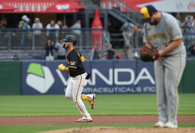 May 22, 2025; Pittsburgh, Pennsylvania, USA;  Pittsburgh Pirates first baseman Spencer Horwitz (2) circles the bases on a solo home run against Milwaukee Brewers starting pitcher Aaron Civale (right) during the fourth inning at PNC Park. Mandatory Credit: Charles LeClaire-Imagn Images
