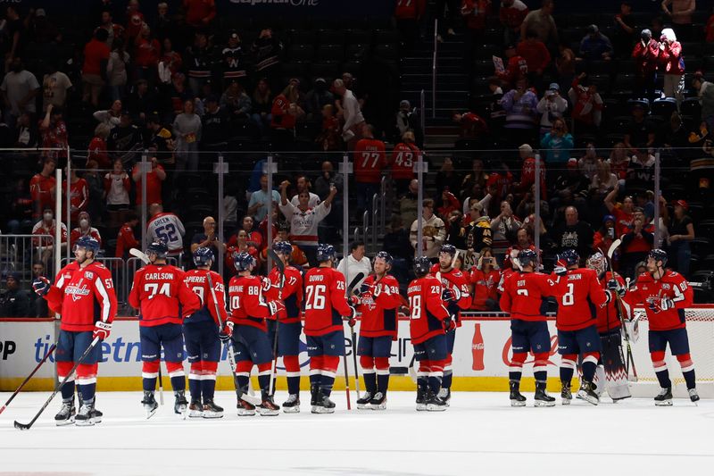 Oct 5, 2024; Washington, District of Columbia, USA; Washington Capitals players celebrate after their game against the Boston Bruins at Capital One Arena. Mandatory Credit: Geoff Burke-Imagn Images