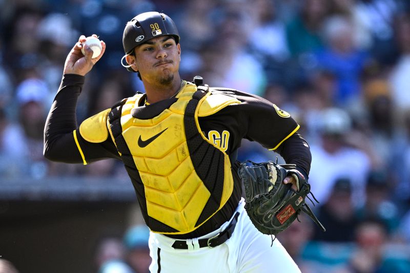 Mar 26, 2024; San Diego, California, USA; San Diego Padres catcher Ethan Salas throws to first base during the ninth inning against the Seattle Mariners at Petco Park. Mandatory Credit: Orlando Ramirez-USA TODAY Sports