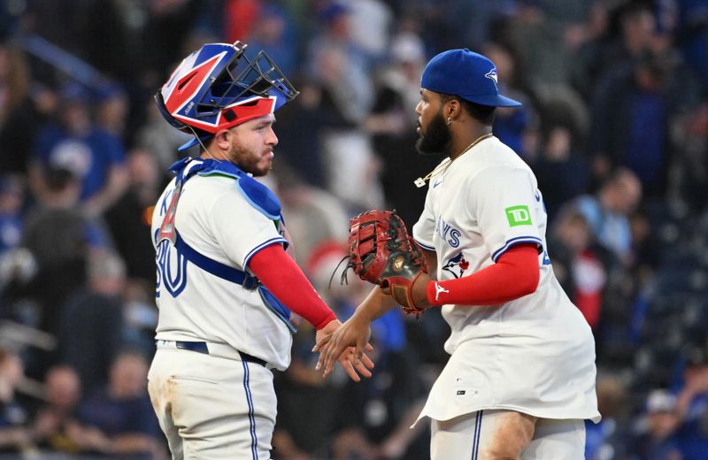 May 14, 2025; Toronto, Ontario, CAN;  Toronto Blue Jays catcher Alejandro Kirk (30) celebraes with first baseman Vladimir Guerrero Jr. (27) after a win over the Tampa Bay Rays at Rogers Centre. Mandatory Credit: Dan Hamilton-Imagn Images