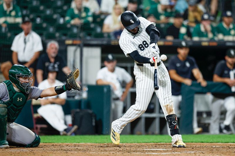 Sep 14, 2024; Chicago, Illinois, USA; Chicago White Sox outfielder Luis Robert Jr. (88) singles against the Oakland Athletics during the seventh inning at Guaranteed Rate Field. Mandatory Credit: Kamil Krzaczynski-Imagn Images