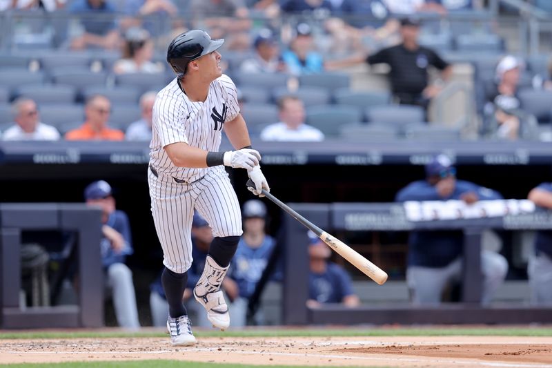 Jul 22, 2024; Bronx, New York, USA; New York Yankees shortstop Anthony Volpe (11) watches his solo home run against the Tampa Bay Rays during the second inning at Yankee Stadium. Mandatory Credit: Brad Penner-USA TODAY Sports