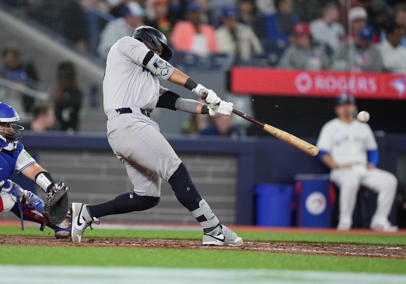 Apr 17, 2024; Toronto, Ontario, CAN; New York Yankees third base Oswaldo Cabrera (95) hits a double against the Toronto Blue Jays during the fifth inning at Rogers Centre. Mandatory Credit: Nick Turchiaro-USA TODAY Sports