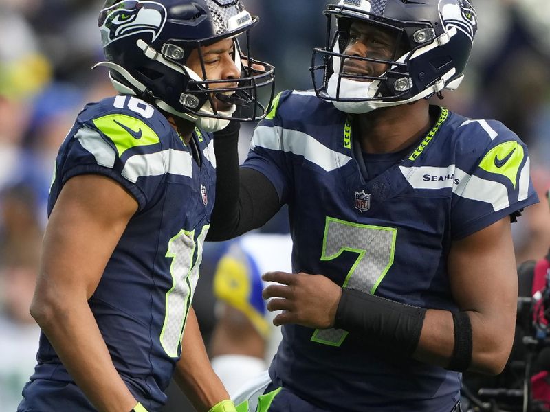 Seattle Seahawks wide receiver Tyler Lockett, left, celebrates after a touchdown pass from quarterback Geno Smith during the first half of an NFL football game against the Los Angeles Rams in Seattle, Sunday, Nov. 3, 2024. (AP Photo/Lindsey Wasson)