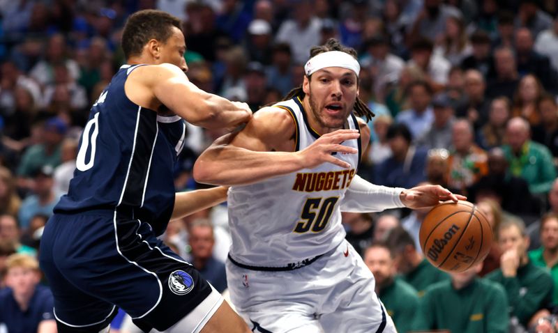 DALLAS, TX - MARCH 17:  Aaron Gordon #50 of the Denver Nuggets handles the ball as Dante Exum #0 of the Dallas Mavericks defends in the first half at American Airlines Center on March 17, 2024 in Dallas, Texas. NOTE TO USER: User expressly acknowledges and agrees that, by downloading and or using this photograph, User is consenting to the terms and conditions of the Getty Images License Agreement. (Photo by Ron Jenkins/Getty Images)