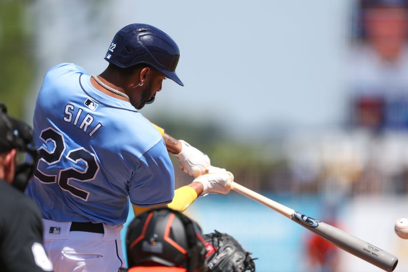 Mar 15, 2024; Port Charlotte, Florida, USA;  Tampa Bay Rays center fielder Jose Siri (22) hits a base hit against the Baltimore Orioles in the second inning at Charlotte Sports Park. Mandatory Credit: Nathan Ray Seebeck-USA TODAY Sports