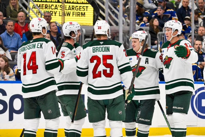 Nov 19, 2024; St. Louis, Missouri, USA;  Minnesota Wild left wing Kirill Kaprizov (97) is congratulated by teammates after scoring against the St. Louis Blues during the third period at Enterprise Center. Mandatory Credit: Jeff Curry-Imagn Images