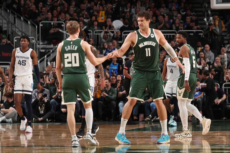 MILWAUKEE, WI - APRIL 3:  AJ Green #20 high fives Brook Lopez #11 of the Milwaukee Bucks during the game against the Memphis Grizzlies on April 3, 2024 at the Fiserv Forum Center in Milwaukee, Wisconsin. NOTE TO USER: User expressly acknowledges and agrees that, by downloading and or using this Photograph, user is consenting to the terms and conditions of the Getty Images License Agreement. Mandatory Copyright Notice: Copyright 2024 NBAE (Photo by Gary Dineen/NBAE via Getty Images).