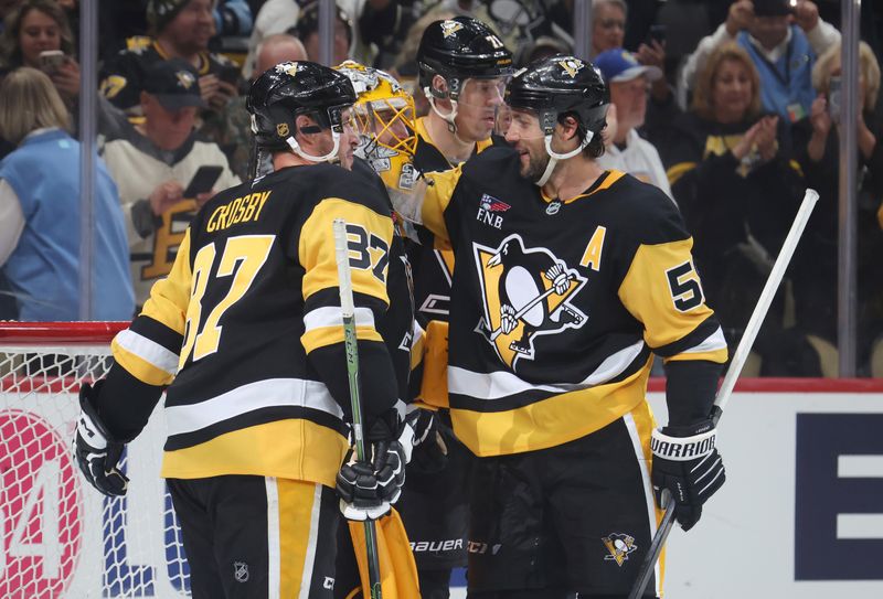 Sep 27, 2025; Pittsburgh, Pennsylvania, USA;  Pittsburgh Penguins goaltender Marc-Andre Fleury (29) is embraced by center Evgeni Malkin (71) and center Sidney Crosby (87) and defenseman Kris Letang (58) after his final NHL game to defeat the Columbus Blue Jackets at PPG Paints Arena. Mandatory Credit: Charles LeClaire-Imagn Images