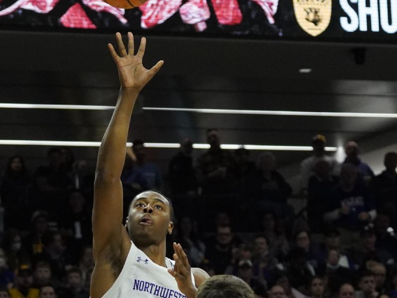 Feb 19, 2023; Evanston, Illinois, USA; Northwestern Wildcats guard Chase Audige (1) shoots over Iowa Hawkeyes forward Filip Rebraca (0) during the second half at Welsh-Ryan Arena. Mandatory Credit: David Banks-USA TODAY Sports