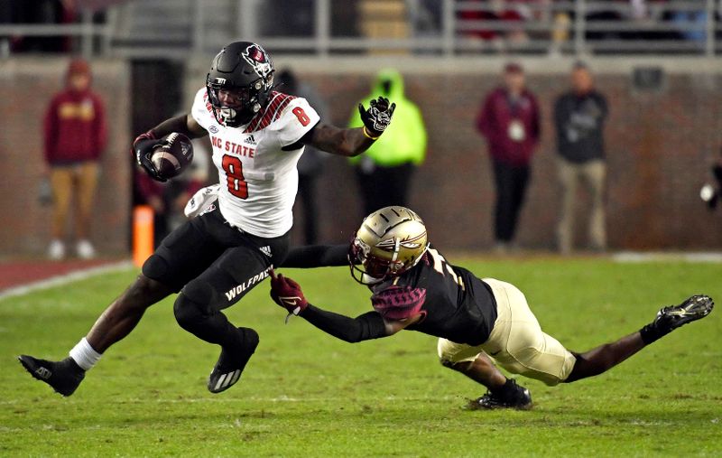 Nov 6, 2021; Tallahassee, Florida, USA; North Carolina State Wolfpack running back Ricky Person Jr. (8) takes a short pass for a touchdown past Florida State Seminoles defensive back Jarrian Jones (7) during the fourth quarter at Doak S. Campbell Stadium. Mandatory Credit: Melina Myers-USA TODAY Sports