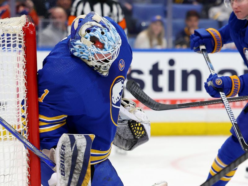 Mar 9, 2024; Buffalo, New York, USA;  Buffalo Sabres goaltender Ukko-Pekka Luukkonen (1) makes a save off his helmet during the first period against the Edmonton Oilers at KeyBank Center. Mandatory Credit: Timothy T. Ludwig-USA TODAY Sports