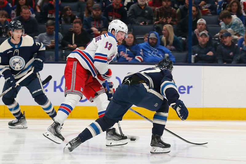 Oct 14, 2023; Columbus, Ohio, USA; New York Rangers left wing Alexis Lafreniere (13) shoots over the stick of Columbus Blue Jackets defenseman Adam Boqvist (27) during the second period at Nationwide Arena. Mandatory Credit: Russell LaBounty-USA TODAY Sports