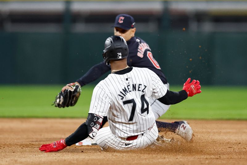 May 9, 2024; Chicago, Illinois, USA; Chicago White Sox designated hitter Eloy Jimenez (74) steals the second base against Cleveland Guardians second baseman Andres Gimenez (0) during the third inning at Guaranteed Rate Field. Mandatory Credit: Kamil Krzaczynski-USA TODAY Sports