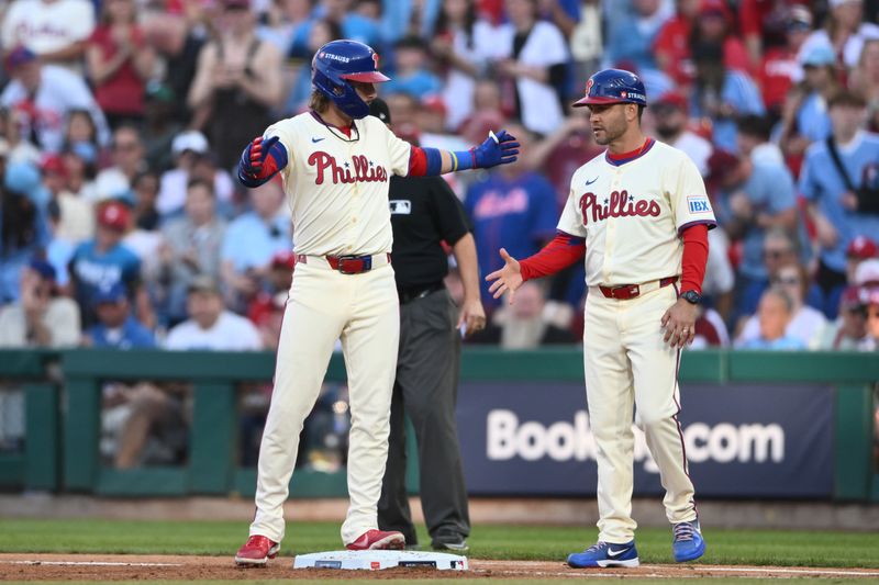 Oct 6, 2024; Philadelphia, Pennsylvania, USA; Philadelphia Phillies second base Bryson Stott (5) celebrates after hitting a single in the fourth inning against the New York Mets during game two of the NLDS for the 2024 MLB Playoffs at Citizens Bank Park. Mandatory Credit: Kyle Ross-Imagn Images