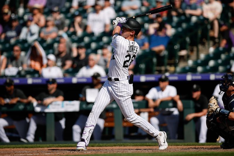 Jul 16, 2023; Denver, Colorado, USA; Colorado Rockies left fielder Nolan Jones (22) hits a two run home run in the eleventh inning against the New York Yankees at Coors Field. Mandatory Credit: Isaiah J. Downing-USA TODAY Sports