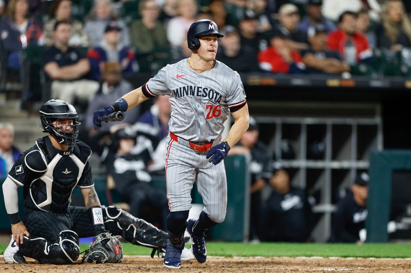 Apr 29, 2024; Chicago, Illinois, USA; Minnesota Twins outfielder Max Kepler (26) hits an RBI-single against the Chicago White Sox during the ninth inning at Guaranteed Rate Field. Mandatory Credit: Kamil Krzaczynski-USA TODAY Sports