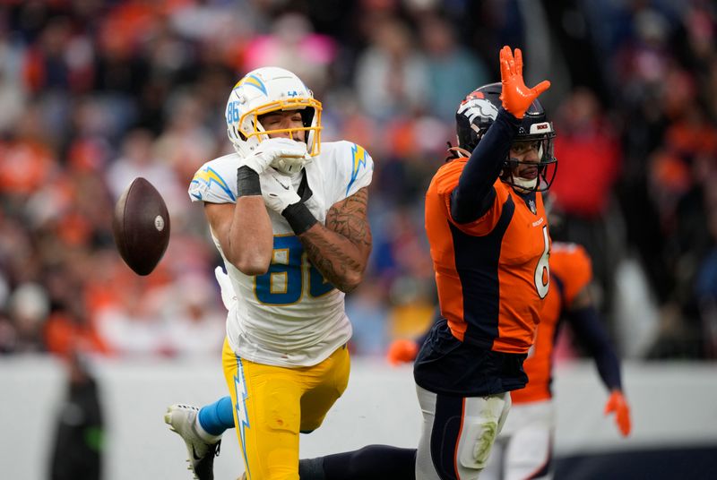 Los Angeles Chargers wide receiver Keelan Doss (86) drops a pass Denver Broncos safety P.J. Locke (6) covers in the second half of an NFL football game in Empower Field at Mile High Sunday, Dec. 31, 2023, in Denver. (AP Photo/David Zalubowski)