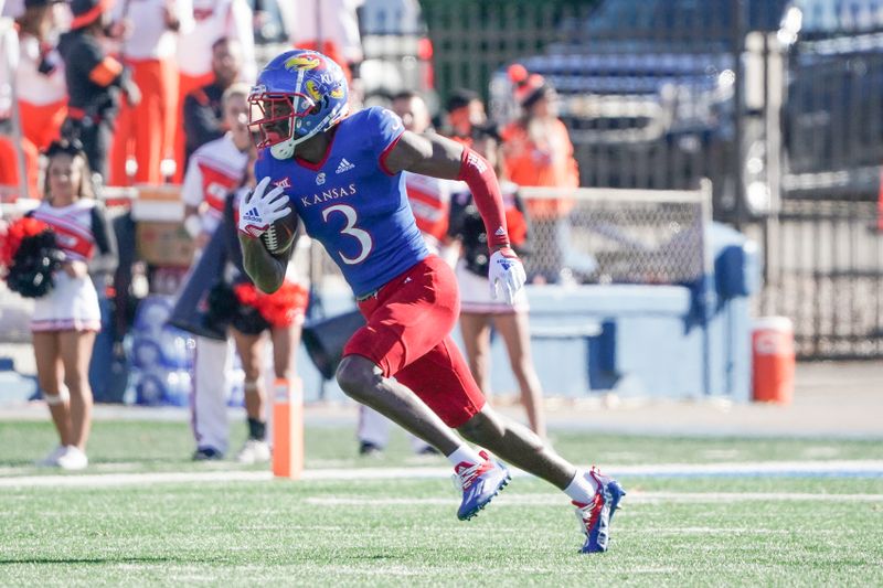 Nov 5, 2022; Lawrence, Kansas, USA; Kansas Jayhawks cornerback Ra'Mello Dotson (3) runs the ball after an interception against the Oklahoma State Cowboys during the first half of the game at David Booth Kansas Memorial Stadium. Mandatory Credit: Denny Medley-USA TODAY Sports