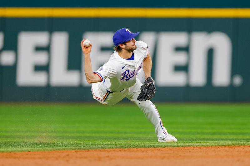 Sep 4, 2024; Arlington, Texas, USA; Texas Rangers shortstop Josh Smith (8) attempts to make a throw over to first base during the third inning against the New York Yankees at Globe Life Field. Mandatory Credit: Andrew Dieb-Imagn Images
