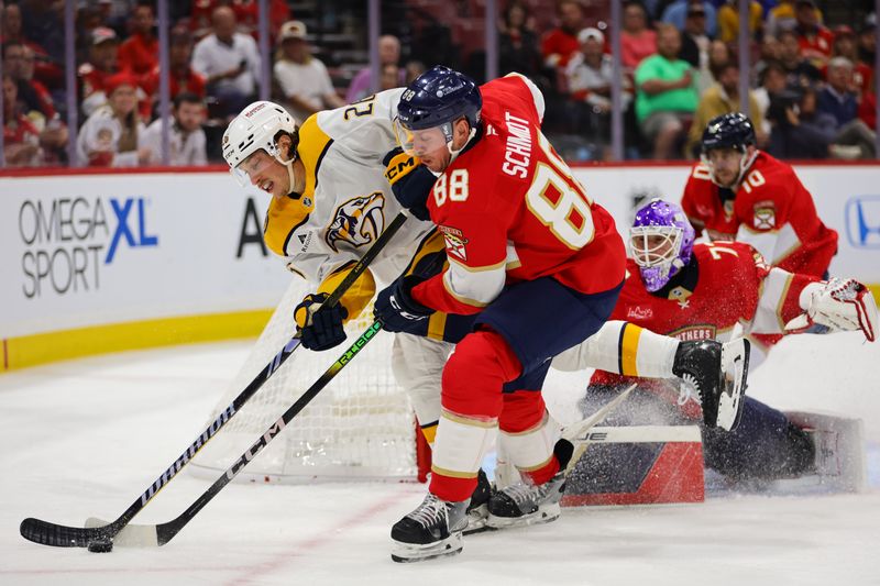 Nov 7, 2024; Sunrise, Florida, USA; Nashville Predators center Philip Tomasino (26) and Florida Panthers defenseman Nate Schmidt (88) battle for the puck during the third period at Amerant Bank Arena. Mandatory Credit: Sam Navarro-Imagn Images