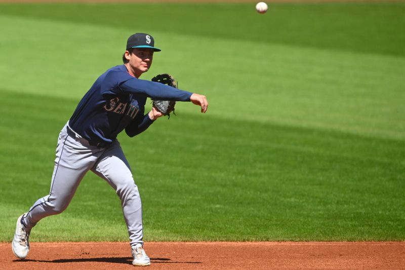 Aug 31, 2025; Cleveland, Ohio, USA; Seattle Mariners second baseman Cole Young (2) throws to first base in the first inning against the Cleveland Guardians at Progressive Field. Mandatory Credit: David Richard-Imagn Images