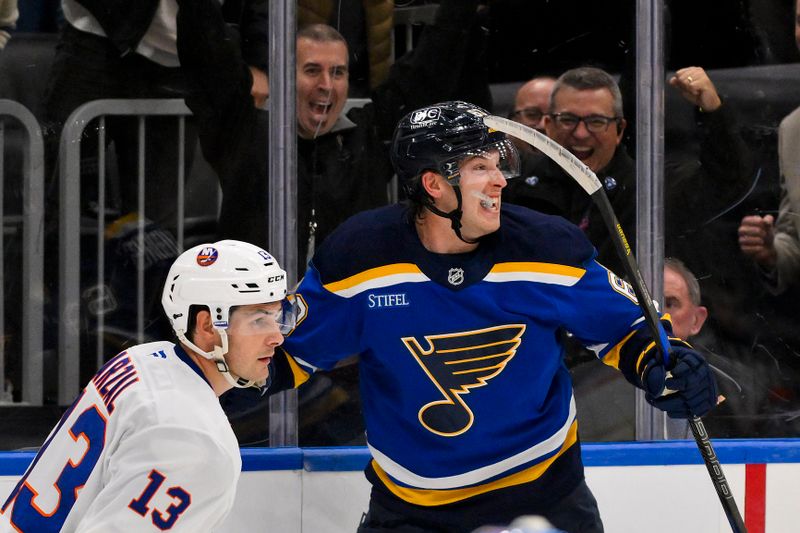 Oct 17, 2024; St. Louis, Missouri, USA;  St. Louis Blues left wing Jake Neighbours (63) reacts after scoring the game winning goal against New York Islanders goaltender Ilya Sorokin (not pictured) in overtime at Enterprise Center. Mandatory Credit: Jeff Curry-Imagn Images