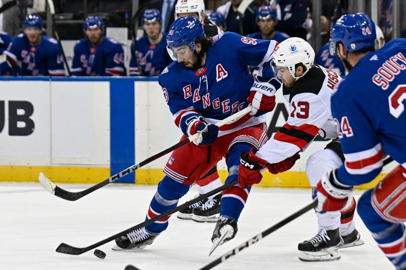 Oct 2, 2025; New York, New York, USA;  New York Rangers center Mika Zibanejad (93) and New Jersey Devils center Nico Hischier (13) battle for the puck during the first period at Madison Square Garden. Mandatory Credit: Dennis Schneidler-Imagn Images