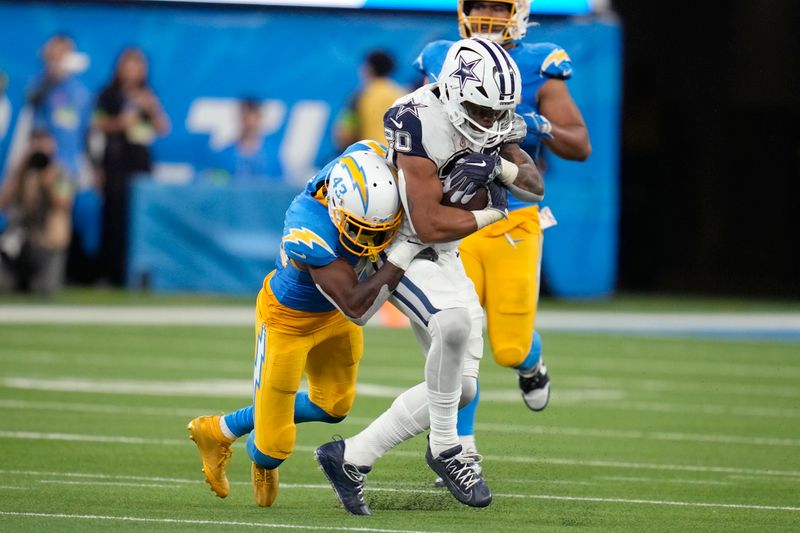 Los Angeles Chargers cornerback Michael Davis (43) tackles Dallas Cowboys running back Tony Pollard (20) during the second half of an NFL football game Monday, Oct. 16, 2023, in Inglewood, Calif. (AP Photo/Ashley Landis)